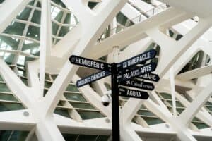 Modern architectural design with directional signs at Valencia's City of Arts and Sciences.