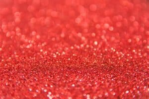 Red Light Therapy For Skin, Shimmering red glitter with bokeh effect, ideal for festive backgrounds.